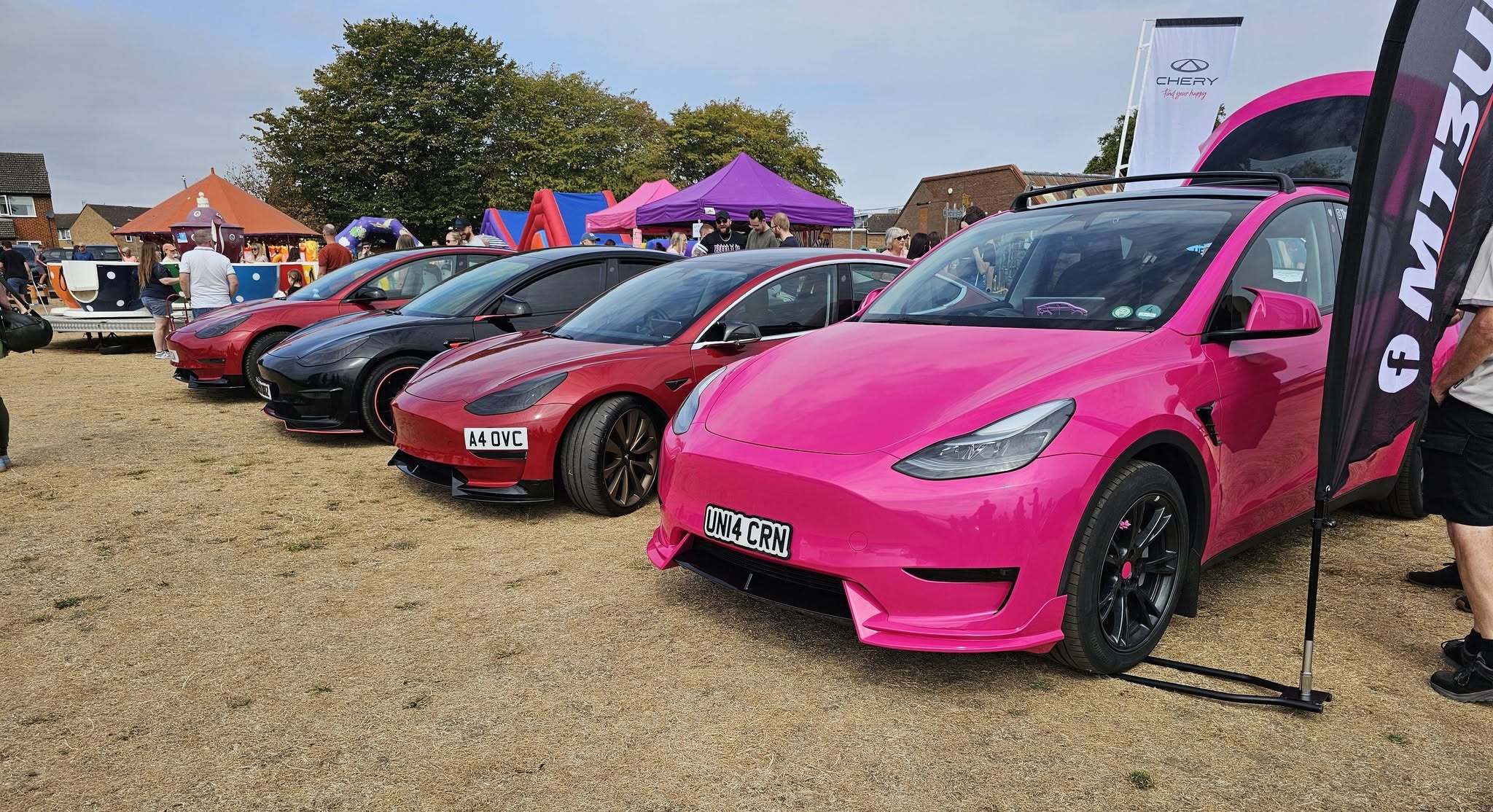 MT3UK members' modified Teslas lined up at a UK car show